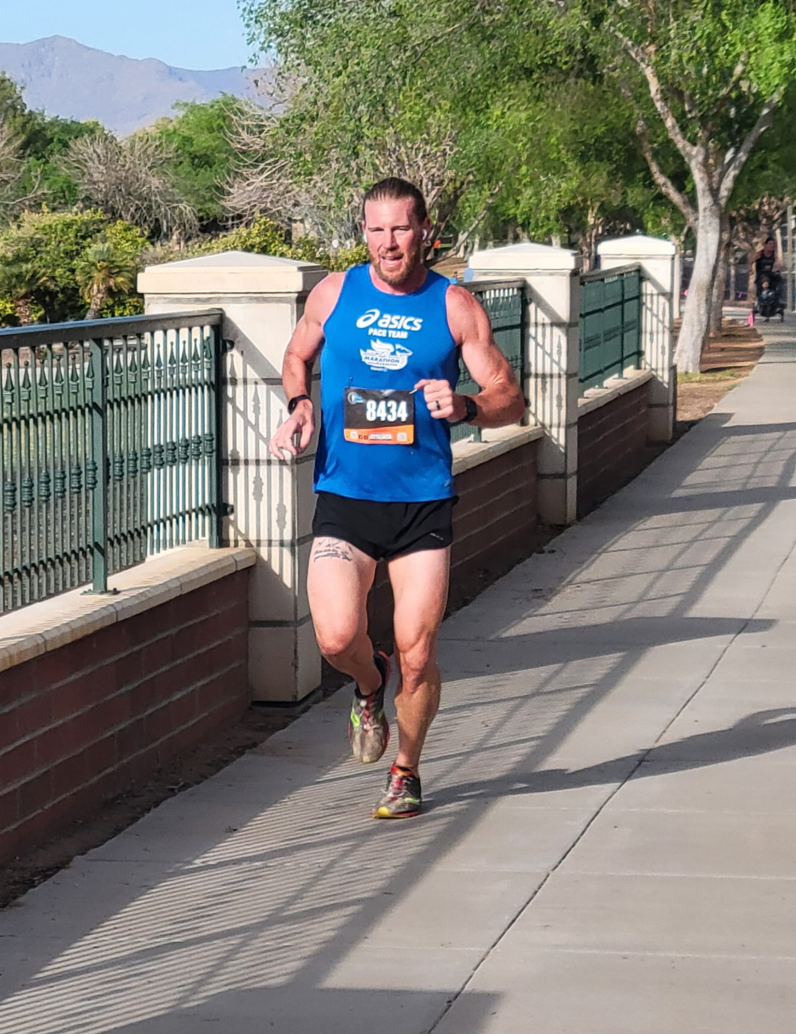 Coach Arrick running down a bridge in a race